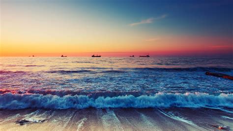 Download 1366x768 Ocean Beach Sunset Horizon Scenic Waves