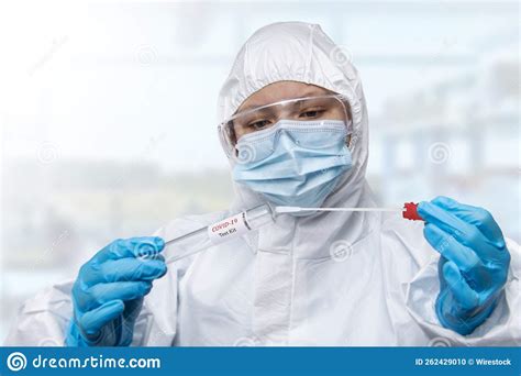 Nhs Technician Holding Covid Swab Collection Kit Wearing White Ppe