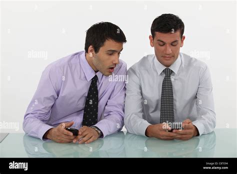 Two Men With Cellphones Stock Photo Alamy
