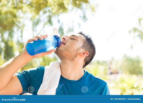 Male Athlete Drinking Water After Workout In Park Stock Photo Image