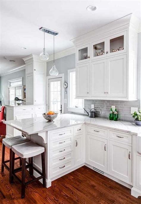 A light wood floor and white subway tile backsplash will help brighten the room while allowing gray cabinets to become the centerpiece of the design. Elegant White Kitchen Design Ideas For More Comfortable ...