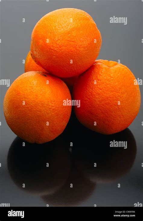 Four Oranges And Their Reflection On A Black Background Stock Photo Alamy