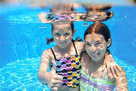 Happy Children Swim In Pool Underwater Girls Swimming 824379 Stock