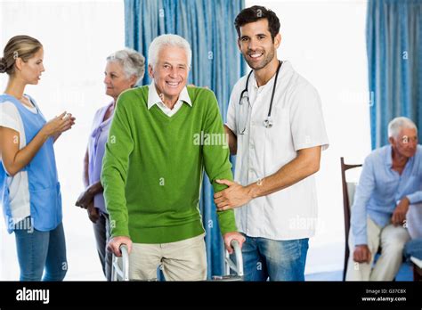 Nurse Helping Senior With Walking Aid Stock Photo Alamy