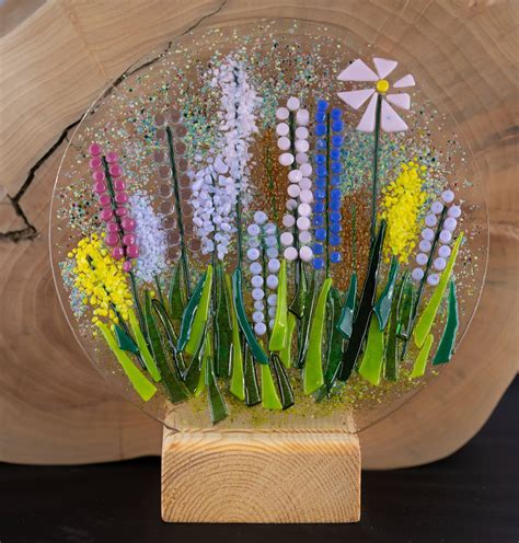 Delphi glass was founded on the belief that making art glass projects should be enjoyable and rewarding for everyone, from budding craftspeople to professional artists. Fused glass wild flower plate with wood tea ligt stand ...