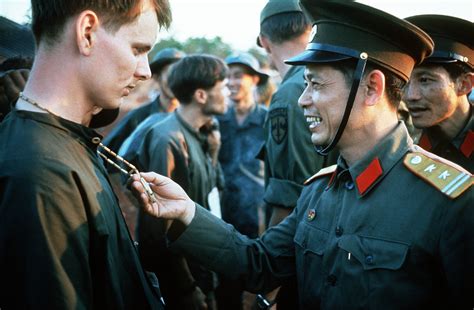 A North Vietnamese Army Officer Laughs At The Peace Symbol Necklace Of