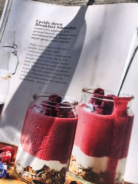 Two Jars Filled With Food Sitting On Top Of A Table Next To An Open Book