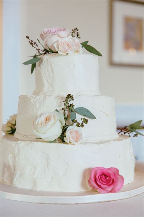 This handmade buttercream cake was made without the use of fondant. White Buttercream Wedding Cake with Roses