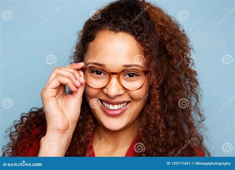 Woman With Glasses And Curly Hair Smiling Against Blue Background Stock Image Image Of Girl