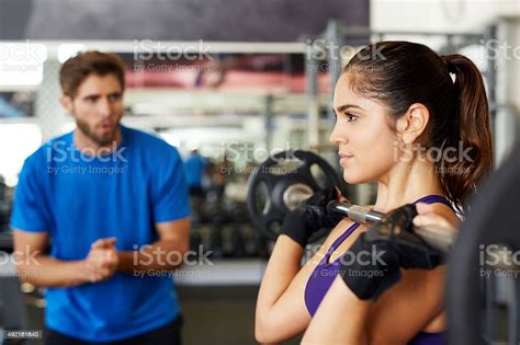 Reaching Her Goals With The Help Of Her Trainer Stock Photo Download
