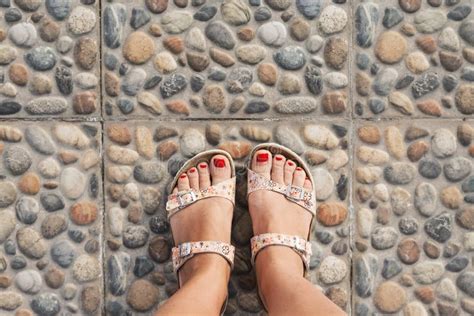 Beautiful Female Bare Bare Tanned Legs With Pink Pedicure On Wooden