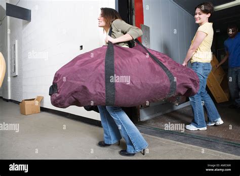 Young Woman Carrying A Huge Traveling Bag Stock Photo Alamy