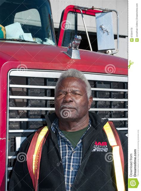 An African American Man Stands In Front Of A Mack Truck Editorial Image