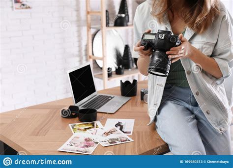 Professional Photographer With Camera Working In Modern Office Closeup