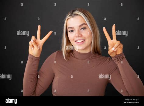 A Beautiful Young Woman In Her 20s Giving Peace Signs Stock Photo Alamy