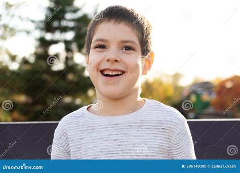 Portrait Of A Smiling Six Year Old Boy In An Autumn Park Happy