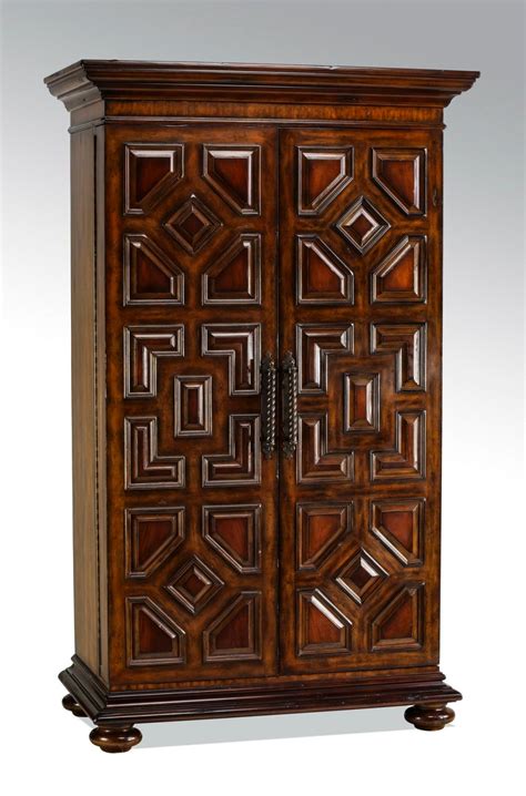Their areas of expertise include metal casting, finely executed porcelains, sophisticated finishing techniques, detailed hand painting, beautiful inlaid marquetry and the finest hand carved woodwork. Lot - Maitland-Smith mahogany bar cabinet