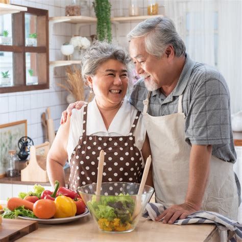 I (to have) a bath. Senior couple having fun in kitchen with healthy food ...