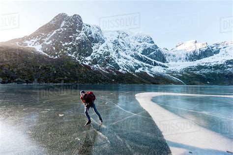 Man Ice Skating On Frozen Lake Stock Photo Dissolve