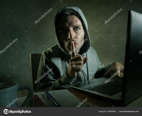 Dangerous Looking Young Hacker Man Hoodie Typing Laptop Computer