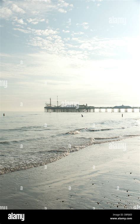 Low Tide On Brighton Beach With Brighton Pier Silhouetted In The Late