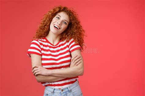 cheerful carefree redhead playful relaxed curly girl tilt head smiling happy cross arms chest