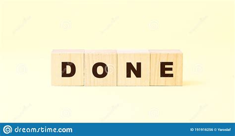 Word Done With Letters On Wooden Blocks On Bright Yellow Stock Photo