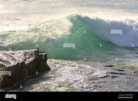 Wave Crashing On The Rocks Stock Photo Alamy