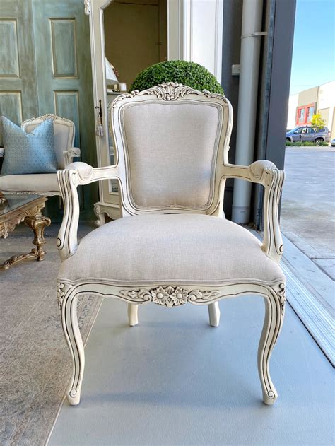 The curved backrest, legs and frame of the chair are finished in a matte black design. French Provincial l Cambria Antique Cream Armchair I ...