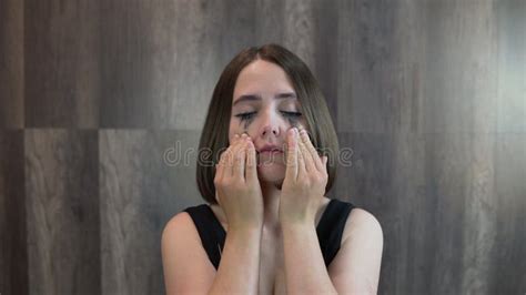 Girl Rubs Her Eyes With Her Hands And Rubs Makeup On Her Face Stock