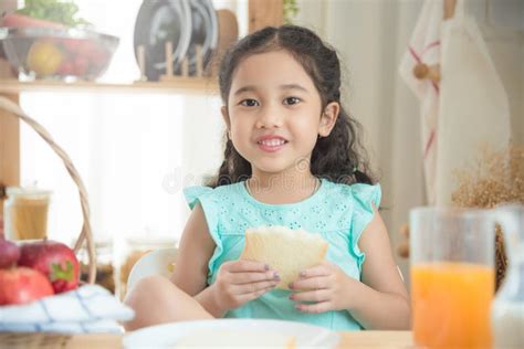 Girl Eating Bread At Breakfast Table Stock Photo Image Of Girl