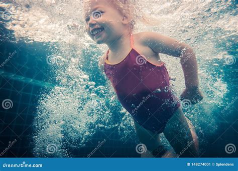 Happy Child Toddler Swimming Underwater In Swimming Pool Stock Image