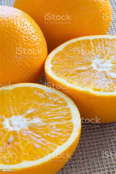 Two Halves Of An Orange And Two Whole Oranges Closeup Stock Photo