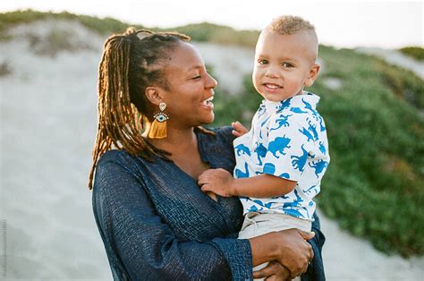 Smiling Black Mother Holding Biracial Son By Stocksy Contributor