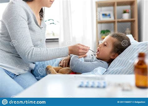 Mother Giving Cough Syrup To Sick Daughter Stock Image Image Of