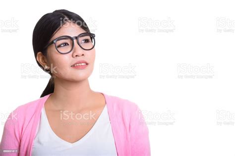 Close Up Of Young Happy Asian Nerd Woman Smiling While Thinking Stock