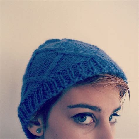 A Close Up Of A Person Wearing A Blue Knitted Hat And Looking At The Camera