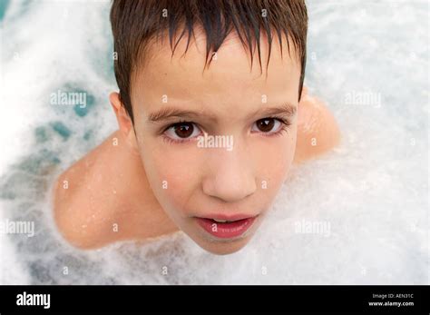 Portrait Of Small Boy Playing In Pool Young Boy Playing In Water