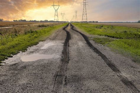 Wet Tire Tracks Running Along A Very Wet Dirt Road Stock Photo Image