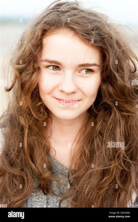 A Teenage Girl With Curly Long Brown Hair Stock Photo Alamy