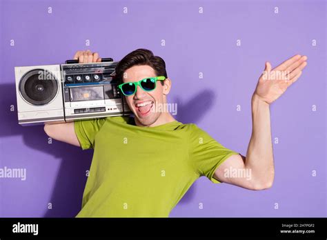 Portrait Of Attractive Cheerful Guy Carrying Boombox Having Fun