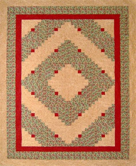 The multiple complimentary fabrics have a fabulous effect as they are pieced beautifully together, while highlighting the center design perfectly. Tami's QIAD Log cabin queen size quilt laid out in the ...
