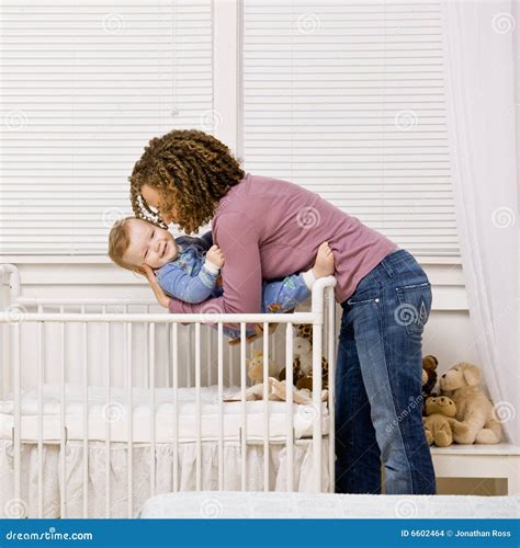 Mother Laying Son Down Into Crib Stock Photo Image Of Laying Origin