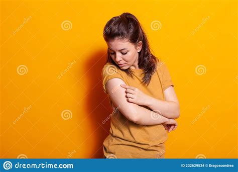 Caucasian Woman Looking At Adhesive Bandaid On Arm Stock Photo Image Of Bandaged Orange