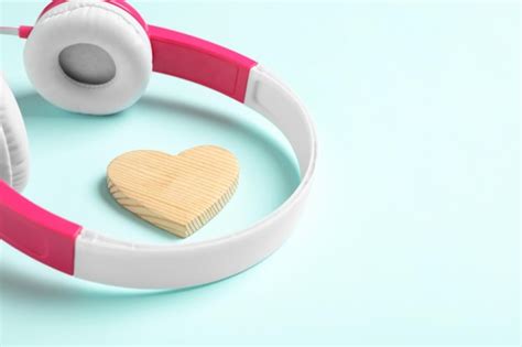 Premium Photo Modern Headphones And Wooden Heart On Turquoise