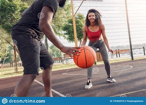 Outdoors Activity African Couple Playing Basketball On Court Dribbling