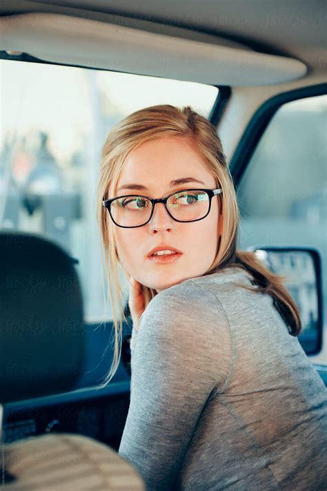 Beautiful Blonde Girl Looking Back Wearing Glasses Inside A Car By Stocksy Contributor Curtis