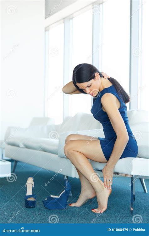 Tired Legs Foot Pain Woman Taking Off Red Shoes On High Heels Royalty