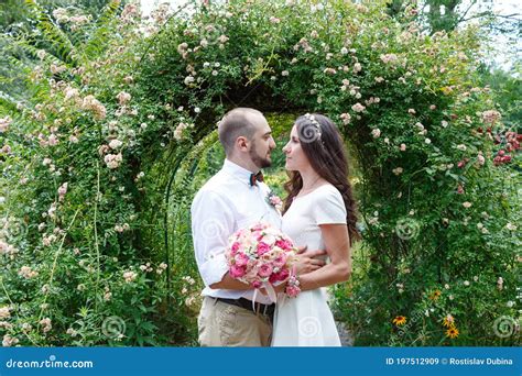 Lovers Newlyweds Beautiful Couple In Love Loving Couple In The Garden Among The Flowers Just