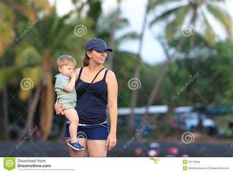 Mother And Son On A Hawaiian Black Sand Beach Stock Photo